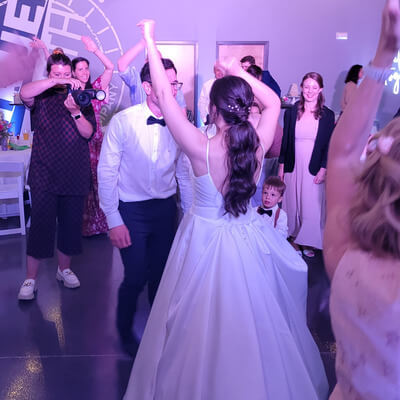 A couple on the dance floor surrounded by guests